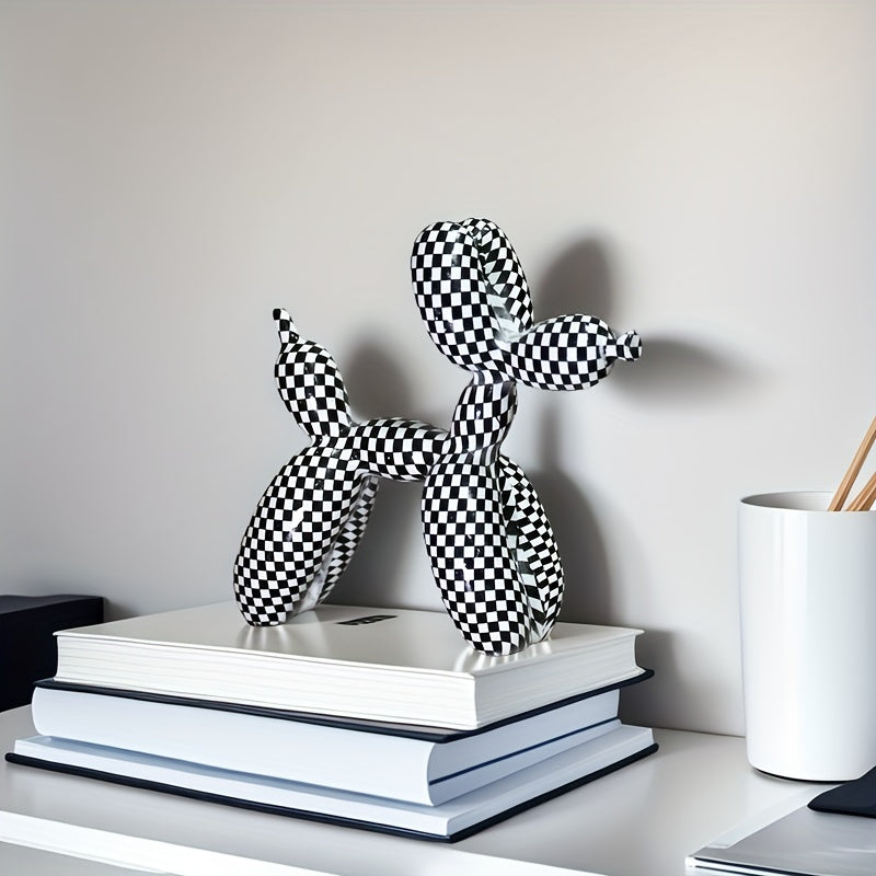 Black and white checkered balloon animal sculpture on a stack of books with a neutral background