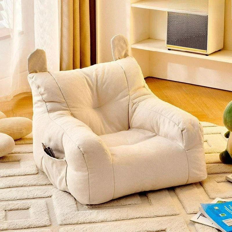 Beige dog sofabed with bunny ears in a cozy living room setting.