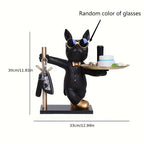 Black dog figurine in a tuxedo with glasses, holding a tray with items, on a white background.
