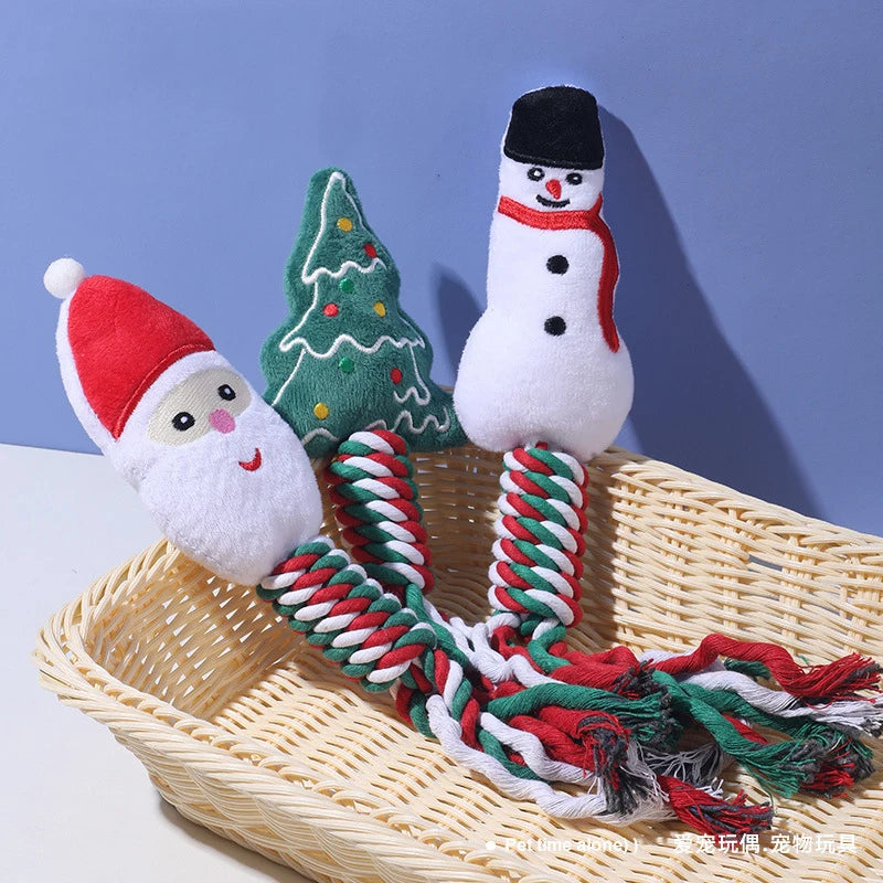 Christmas-themed dog toys including a Santa Claus, a tree, and a snowman on a woven basket with a blue background.