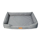 Gray pet bed with white piping on a white background