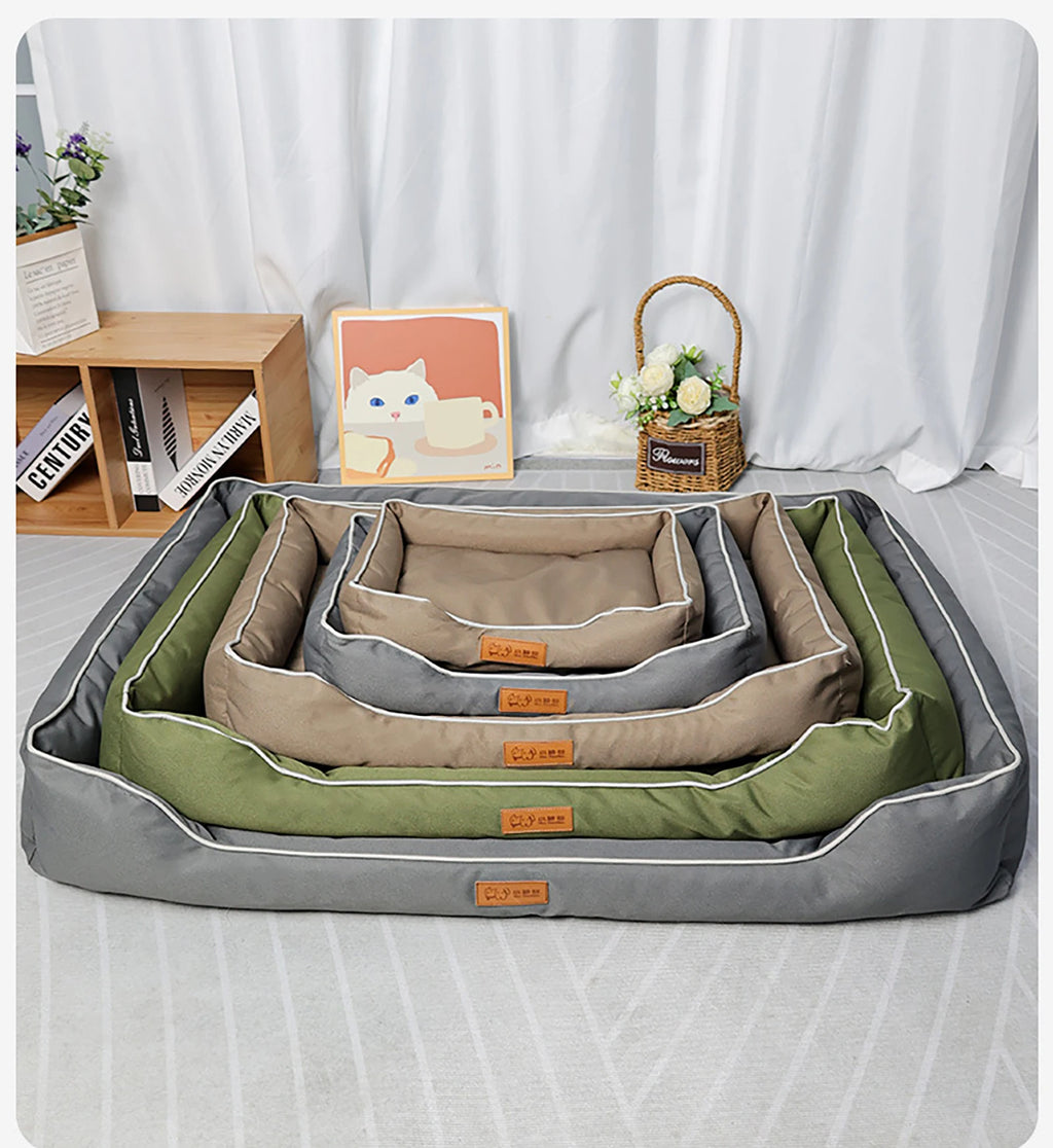 Set of pet beds in green, gray, and beige on a bed with a white curtain background.