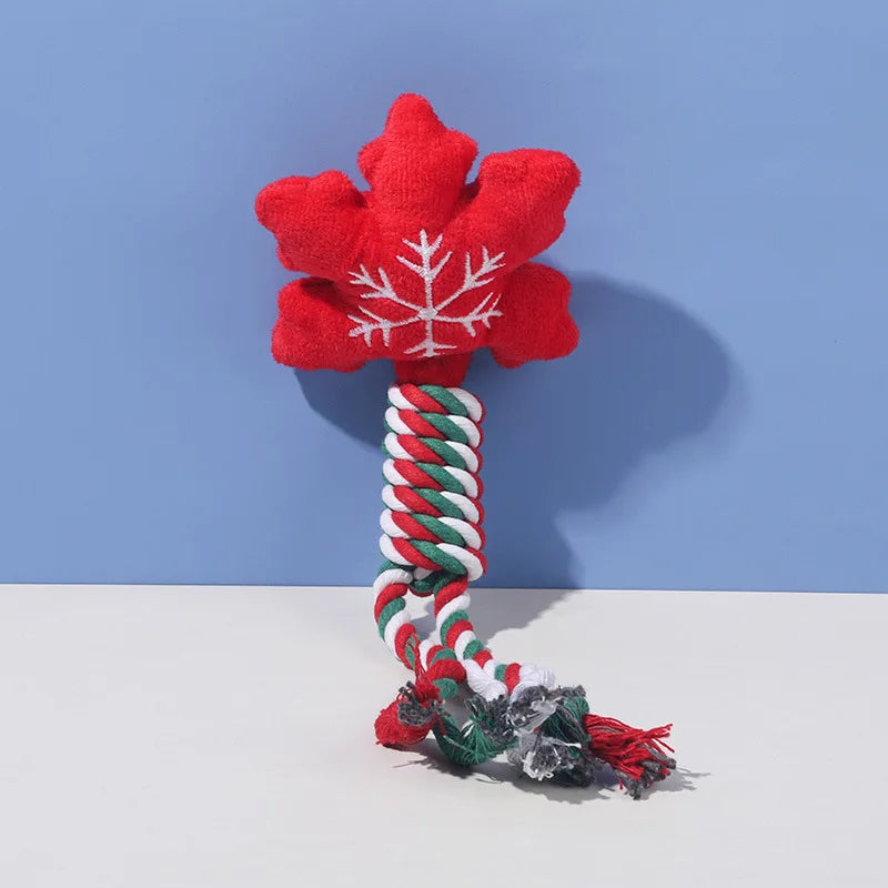 snowflake shaped dog toy with a rope and tassel on a light blue background